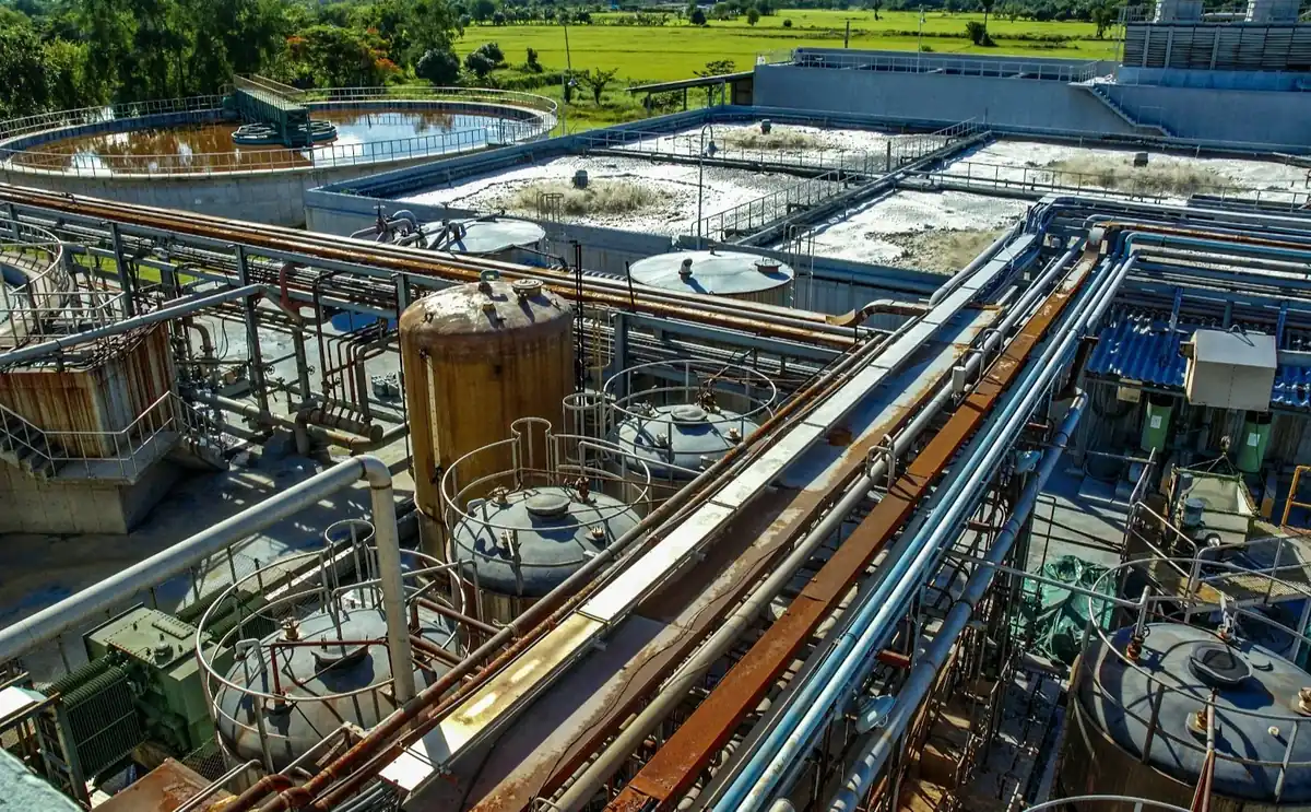 Aerial view of a wastewater treatment plant with settling tanks and treatment basins