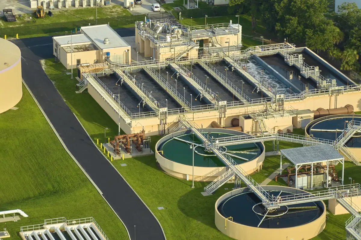 Aerial view of wastewater treatment plant sequencing basins and circular clarifiers