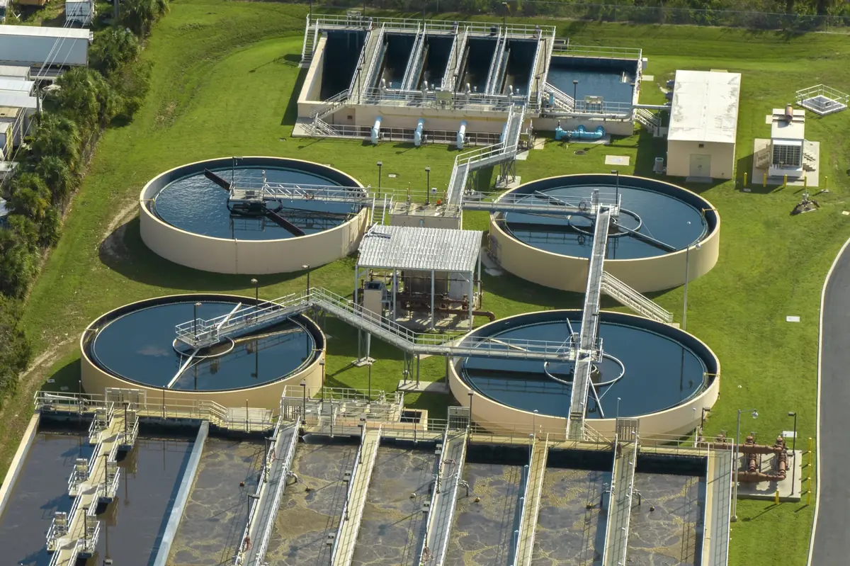 Circular clarifier tanks at a wastewater treatment plant, the kind of infrastructure environmental engineers design and operate